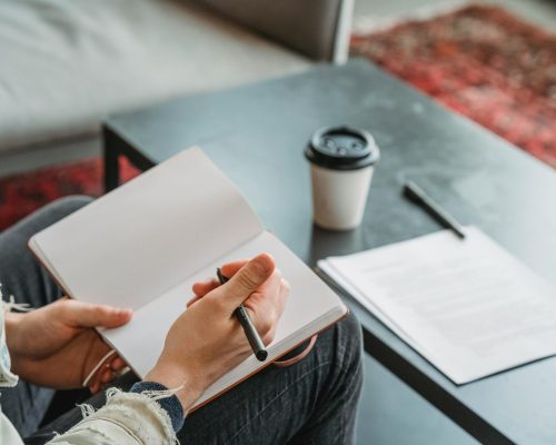 Visual comparison of self-editing vs hiring an editor, showing a lone author refining a draft on one side and an editor providing structured feedback on a manuscript on the other, emphasizing depth of revision and expertise.