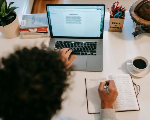 Split-screen illustration comparing self-editing (writer revising manuscript alone with notes and software tools) versus hiring an editor (writer collaborating with a professional editor reviewing marked-up pages), highlighting differences in feedback and workflow.